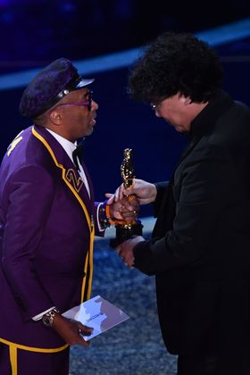 South Korean film director Bong Joon Ho (R) accepts the award for Best Director for "Parasite" from US director Spike Lee (L) during the 92nd Oscars at the Dolby Theatre in Hollywood, California on February 9, 2020. (Photo by Mark RALSTON / AFP)