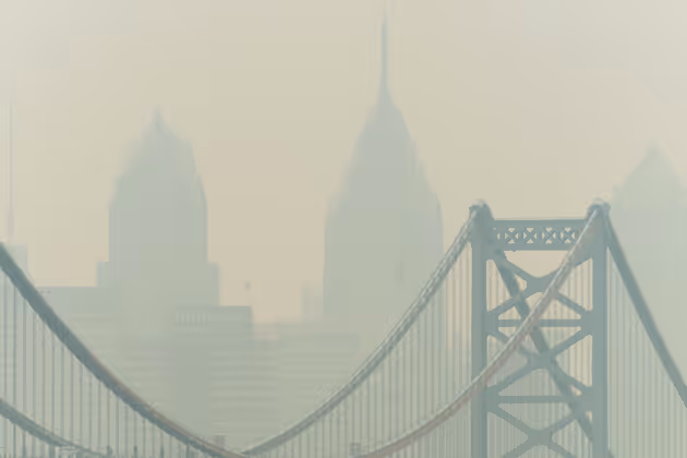 Smoke from Canada's wildfires casts a haze over the Philadelphia skyline, as seen from Camden, New Jersey on June 7, 2023. An orange-tinged smog caused by Canada's wildfires shrouded New York on June 7, 2023, obscuring skyscrapers and causing residents to don face masks, as cities along the US East Coast issued air quality alerts. (Photo by Joe LAMBERTI / AFP)