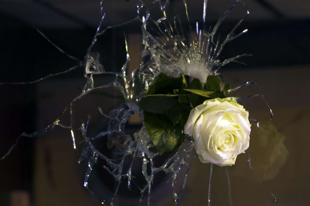 Noch in der Nacht steckte jemand eine Rose durch ein Einschussloch in einem Restaurant, in dem bei der Schießerei unzählige Menschen starben.