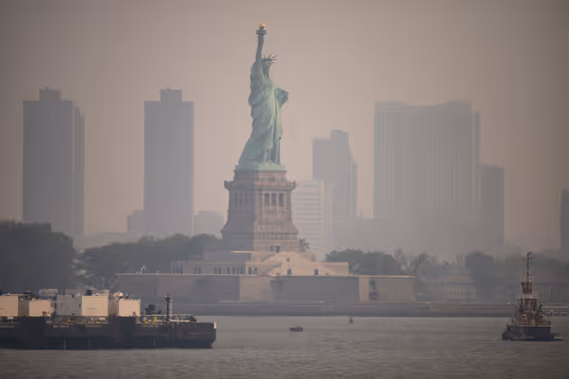 The Statue of Liberty from the Staten Island Ferry during heavy smog in New York on June 6, 2023. Smoke from Canadaís wildfires has engulfed the Northeast and Mid-Atlantic regions of the US, raising concerns over the harms of persistent poor air quality. (Photo by Ed JONES / AFP)
