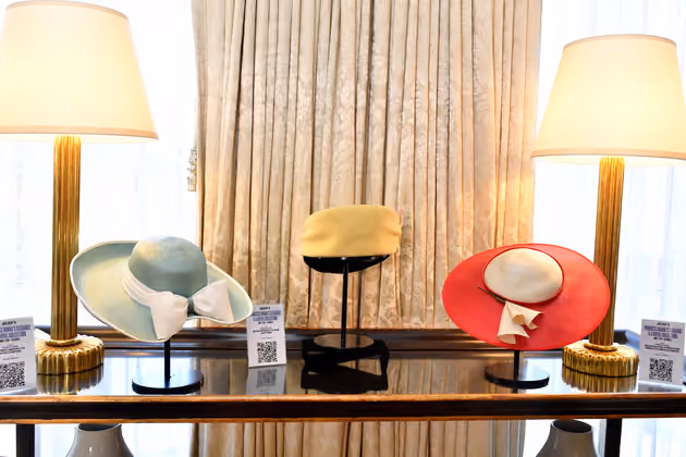 Princess Diana's hats by Philip Somerville (L-R) 1989 teal hat, 1987 yellow and black turban, and red and cream straw hat worn on tour in Australia are on display at Julien's Auctions' press preview of "Princess Diana's Elegance & a Royal Collection", ahead of an exclusive private showing at the Peninsula Beverly Hills, Beverly Hills, California, June 25. (Photo by VALERIE MACON / AFP)